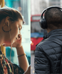 A woman wearing in-ear earphones and the back of a man's head. The man is wearing headphones