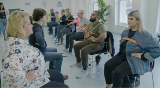 People sitting in a group therapy setting