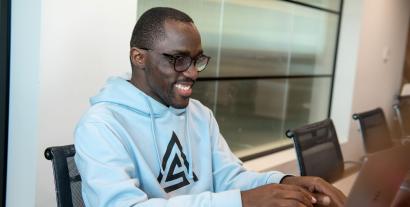 A man sitting at a desk working on a laptop