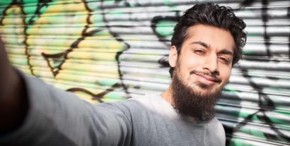 A young man taking a selfie and smiling