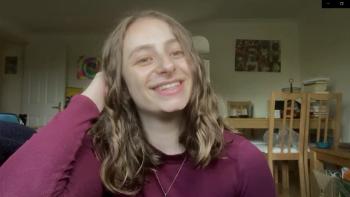 A woman looking at the camera and smiling