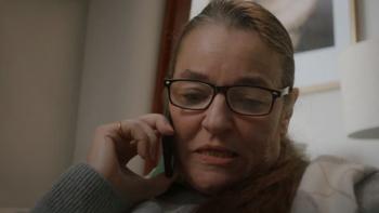 A woman speaking into a telephone
