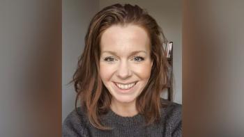 A woman looking off camera and smiling