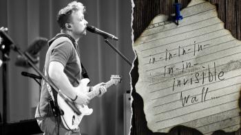 A man singing into a microphone and playing the guitar, with an inset of a scrap of lined paper with writing on it.