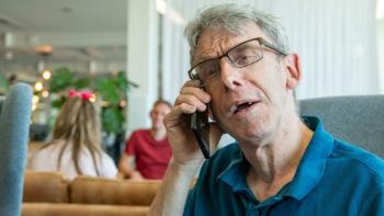 A man speaking into a telephone