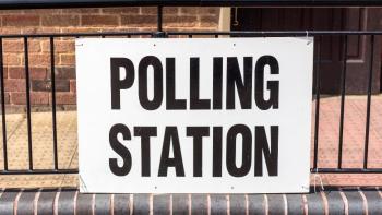 A sign saying 'Polling station' attached to railings
