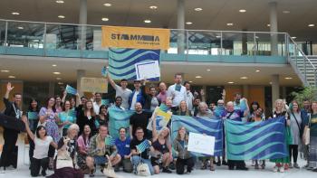 A group of people holding flags and waving