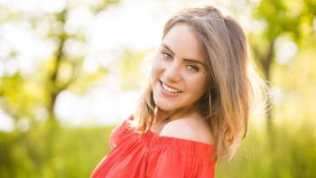 A woman in an outdoor setting smiling