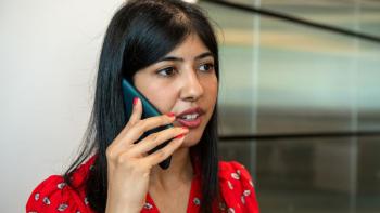 A woman speaking into a phone
