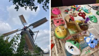 A windmill and a table with freshly-painted masks on it