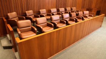 A juror's box with empty seats inside