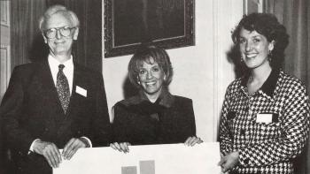 A man and two women holding a banner with 'British Stammering Association' on it