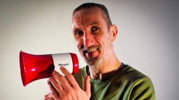 A man holding a megaphone and smiling