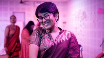 A woman in traditional Indian dress, smiling