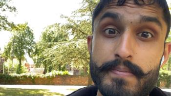 A close up of man's face in a park