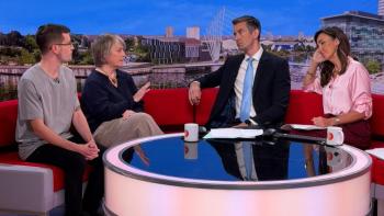 Four people sitting on a sofa in a tv studio, a man and a woman on the left, speaking to another man and woman on the right