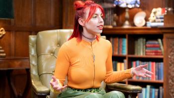 A young woman sitting in an armchair with her arms open