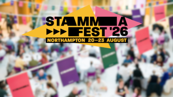 A logo saying 'STAMMAFest 2026' against a blurred picture of people seated at tables in a conference setting