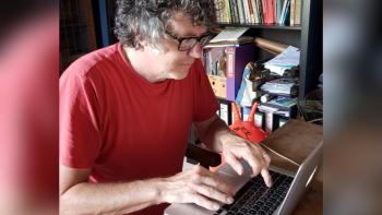 A man typing on a laptop keyboard