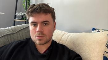 A man sitting on a sofa looking serious