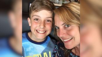 A mother and son, both smiling
