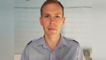A man in a uniform looking at the camera