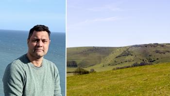 A man with the ocean behind him, next to a field in the Sussex countryside