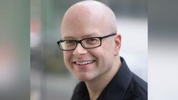 A man in glasses smiling