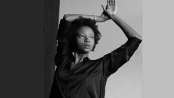 A woman with her arms in the air, looking to the side