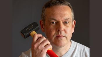A man holding up a hammer
