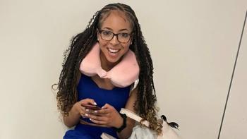 A young woman holding a mobile phone and smiling