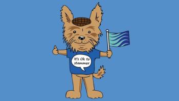 An illustrated dog wearing a t-shirt and flat cap, holding a flag. On its t-shirt it says 'It's okay to stammer'