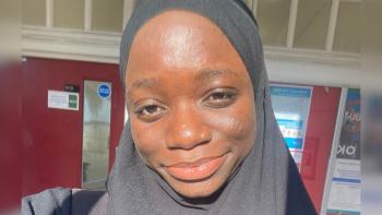 A woman in a headscarf, smiling