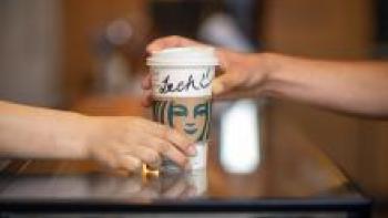 Passing over a Starbucks cup re barista training