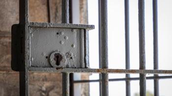 A lock on a prison barred door