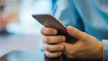 A pair of hands holding a mobile phone