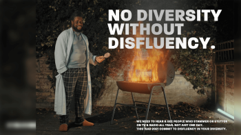 A man standing next to a barbecue that has flames coming out of it.