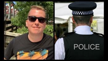 A man in sunglasses smiling for the camera, with the back of a policeman's head next to him