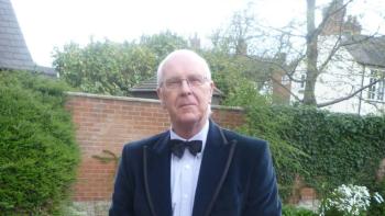 A man in an evening suit looking at the camera