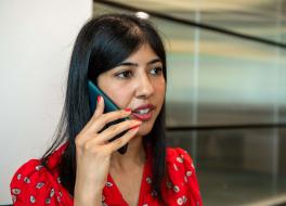 A woman speaking into a mobile phone