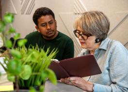 what to do when speech therapy isn't working A woman looking at a tablet, with a man sat next to her watching on