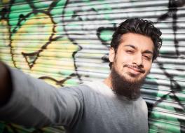 A young man taking a selfie photograph