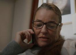 A woman speaking into a telephone