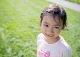 A young girl looking at the camera and smiling