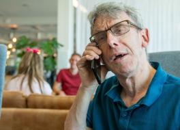 A man speaking into a telephone