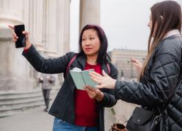 A woman giving directions to another woman in the street