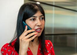 A woman speaking into a phone