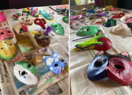 Lots of brightly painted masks on a table