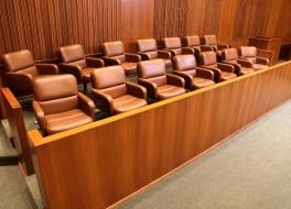 A juror's box with empty seats inside