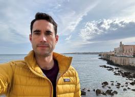 A man by the coast taking a selfie